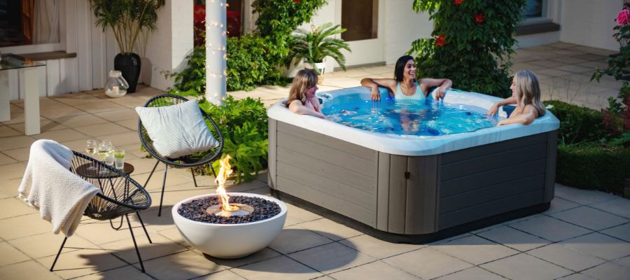Women enjoying a spa from Spa World Bundaberg in a nice outdoor setting